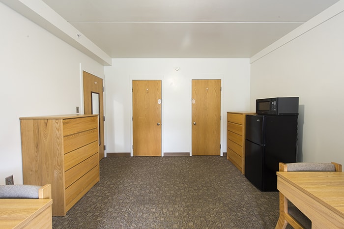 West Wing Semi-Suite Double - two closets dressers desks and a refrigerator